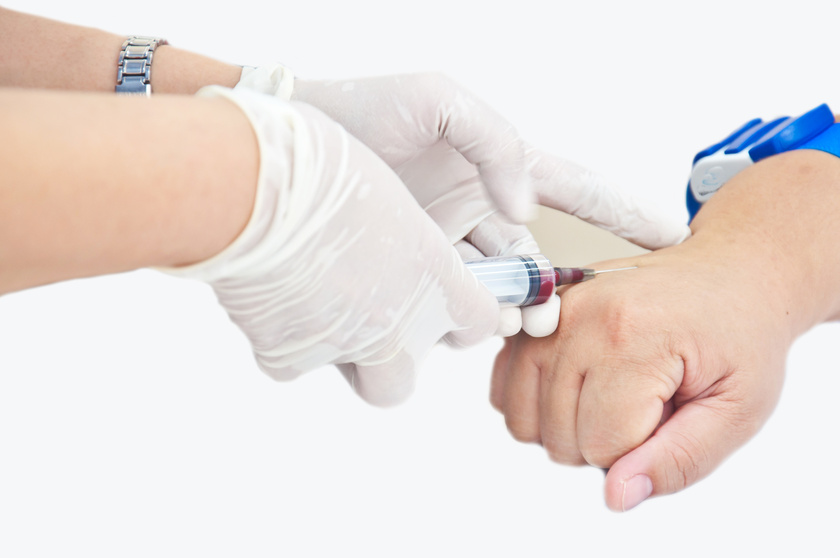 Nurse Hand Injecting Syringe to Patient's Hand for Bloodtest